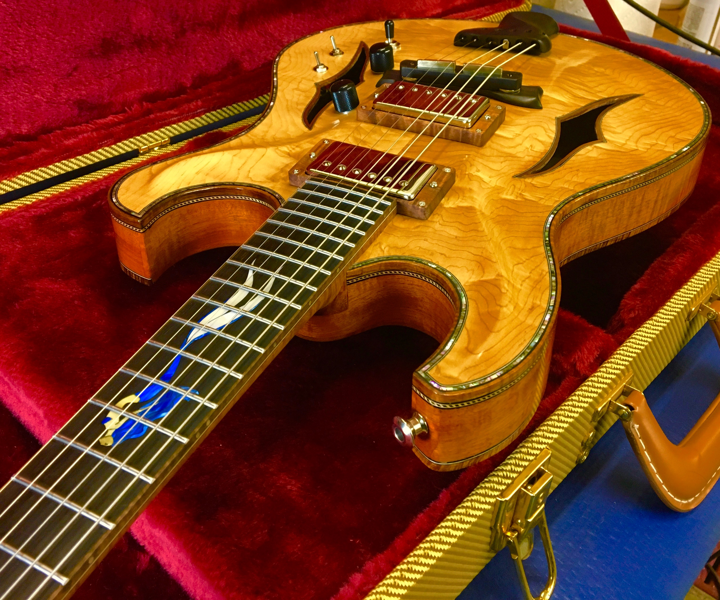 Handcrafted archtop guitar with custom inlay work and quilted maple